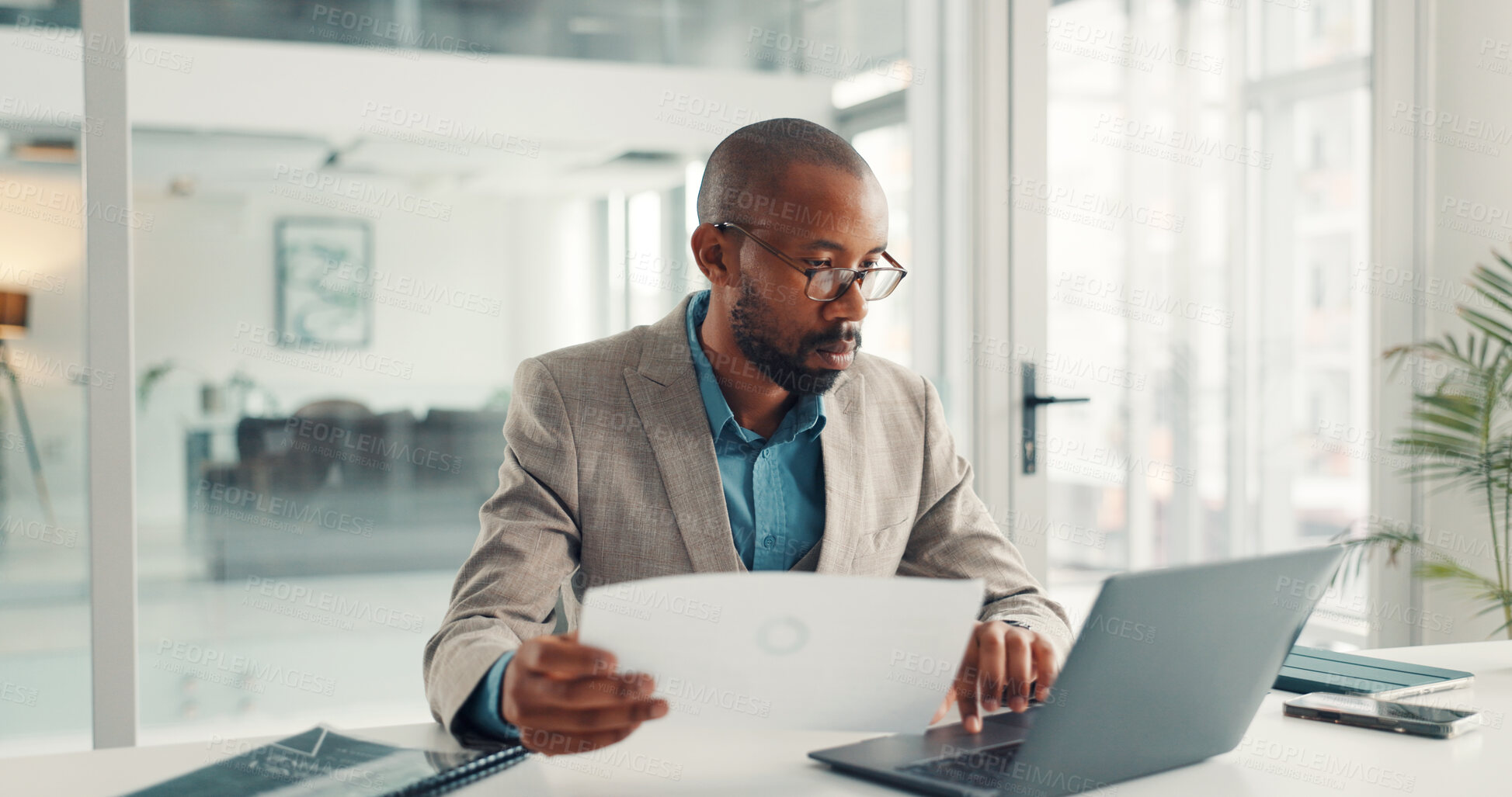 Buy stock photo Office, typing and businessman with laptop, paperwork and data analysis on web, online and research. Investment banker, black person and planning for pitch with technology, document and checking info