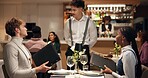 Waiter, couple and talk at restaurant with menu, decision and discussion for wine list, food or order. People, server and customer experience with service, question and opinion for choice at dinner