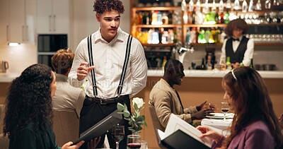Buy stock photo Waiter, friends and order at restaurant with menu, decision and discussion for wine list, food or service. Women, man and customer experience with talk, explain and questions for choice at dinner