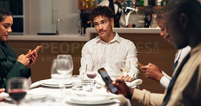Buy stock photo Man, bored and group at restaurant with phone addiction, social isolation and annoyed at dinner. Person, friends and smartphone with mobile app, chat and bad manners with frustrated thinking at diner