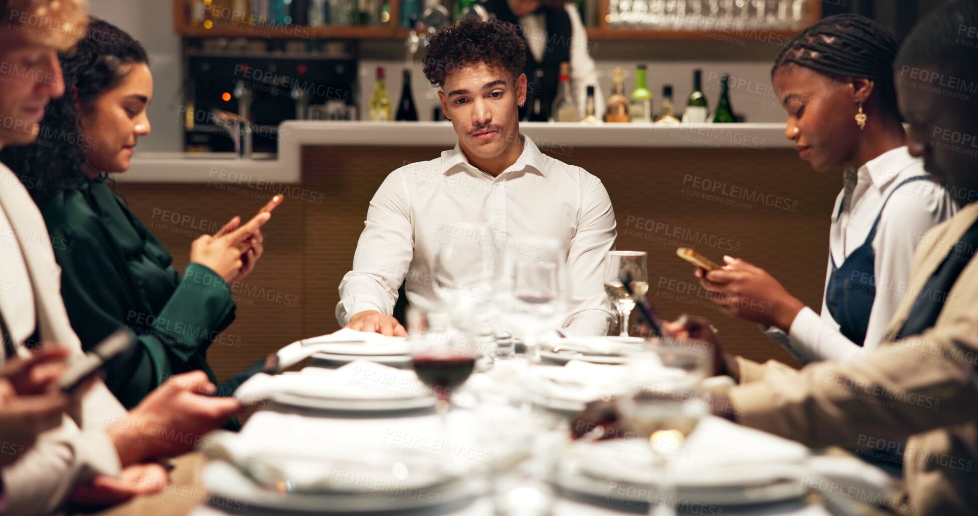 Buy stock photo Man, annoyed and group at restaurant with phone addiction, social isolation and bored at dinner. Person, friends and smartphone with mobile app, chat and lonely with frustrated thinking at diner