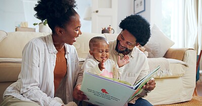 Buy stock photo Happy, black family and reading book with child in home for story, bonding or childhood development. Mom, dad and toddler with kids novel, dinosaur or smile for learning or fantasy together in house