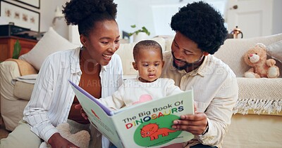 Buy stock photo Happy, black family and dinosaur book with child in home for story, bonding or childhood development. Mom, dad and reading with toddler, kids novel or smile for learning or fantasy together in house