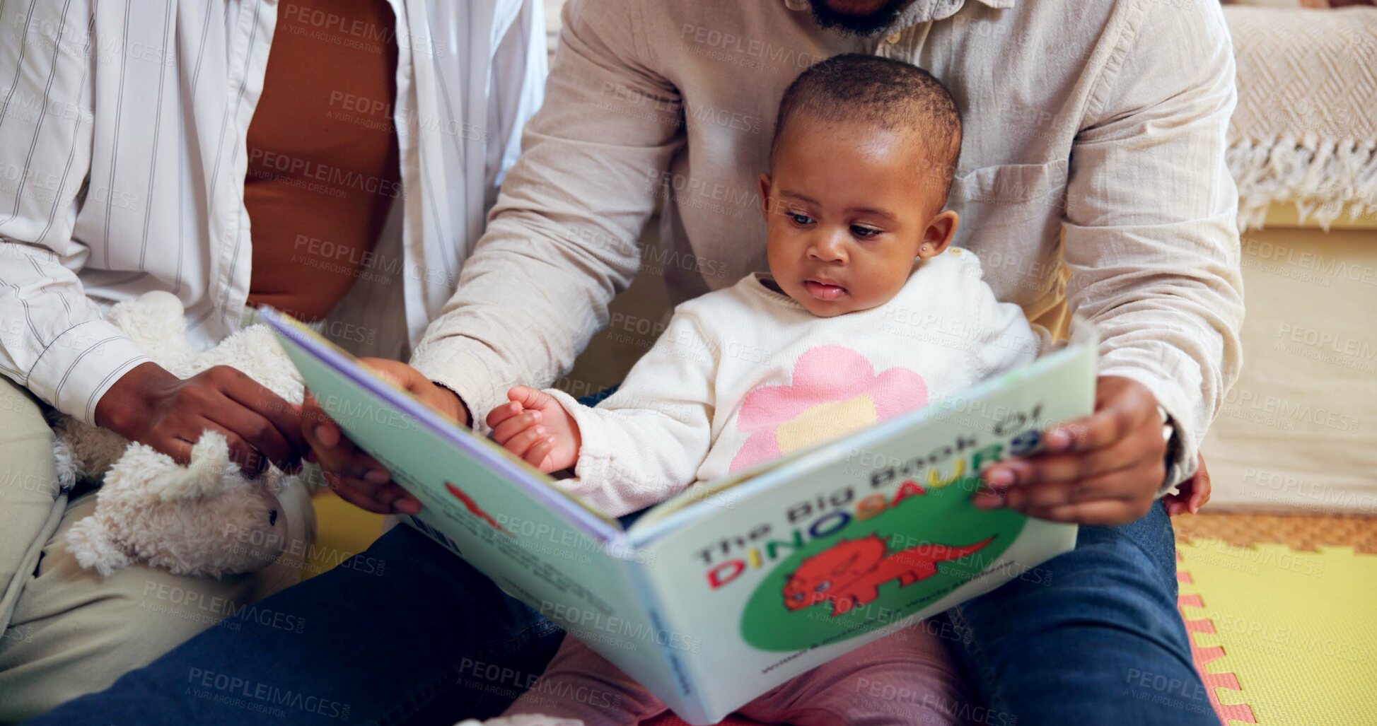 Buy stock photo Family, child or reading with dinosaur book in home for story or childhood development. Mom, dad or toddler with kids novel, fairytale or literature for learning, bonding or fantasy together in house