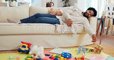 Buy stock photo Fatigue, sleeping and toys with black man on sofa in living room of home for break or rest. Asleep, burnout and tired with exhausted African father in apartment for chilling, dreaming or recovery