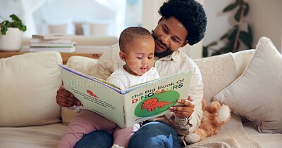 Buy stock photo Black dad, child and reading with dinosaur book in home for story or childhood development. Father, kid or toddler with novel, youth or literature for learning, bonding or fantasy together in house