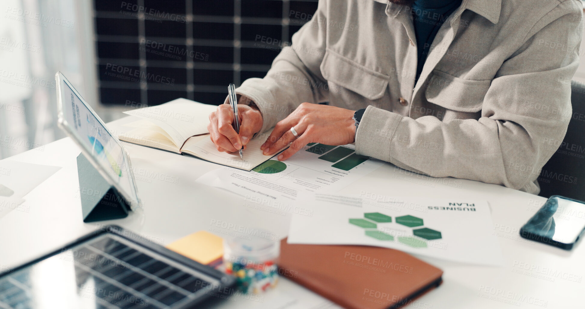 Buy stock photo Hands, writing or tablet in office with notebook for research, solar energy plan and data analysis. Person, notes and planner in sustainable business with tech, photovoltaic system review and graphs.