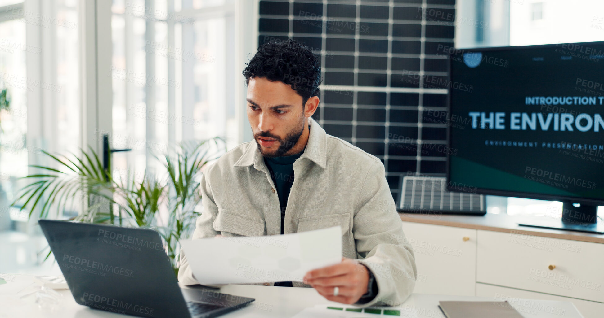 Buy stock photo Businessman, reading and document with laptop in office for research, energy saving stats and results. Person, pc and paperwork on photovoltaic grid revenue, company performance and solar panel sales