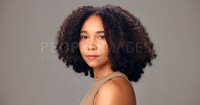 Buy stock photo Haircare, portrait and woman in studio, confident or maintenance of texture, shine and mockup space. Beauty, African person and serious for healthy hair, gray background and self care for hairstyle