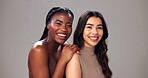 Happy women, portrait or hug with interracial beauty or hair for fashion on a studio background. Female people, model or multiracial skin with hairstyle for spa cosmetics, skincare treatment or salon