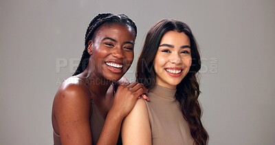 Buy stock photo Happy women, portrait or hug with skincare, beauty or smile for cosmetics on a studio background. Female people, model or multiracial friends with care for cosmetology, inclusion or glowing skin