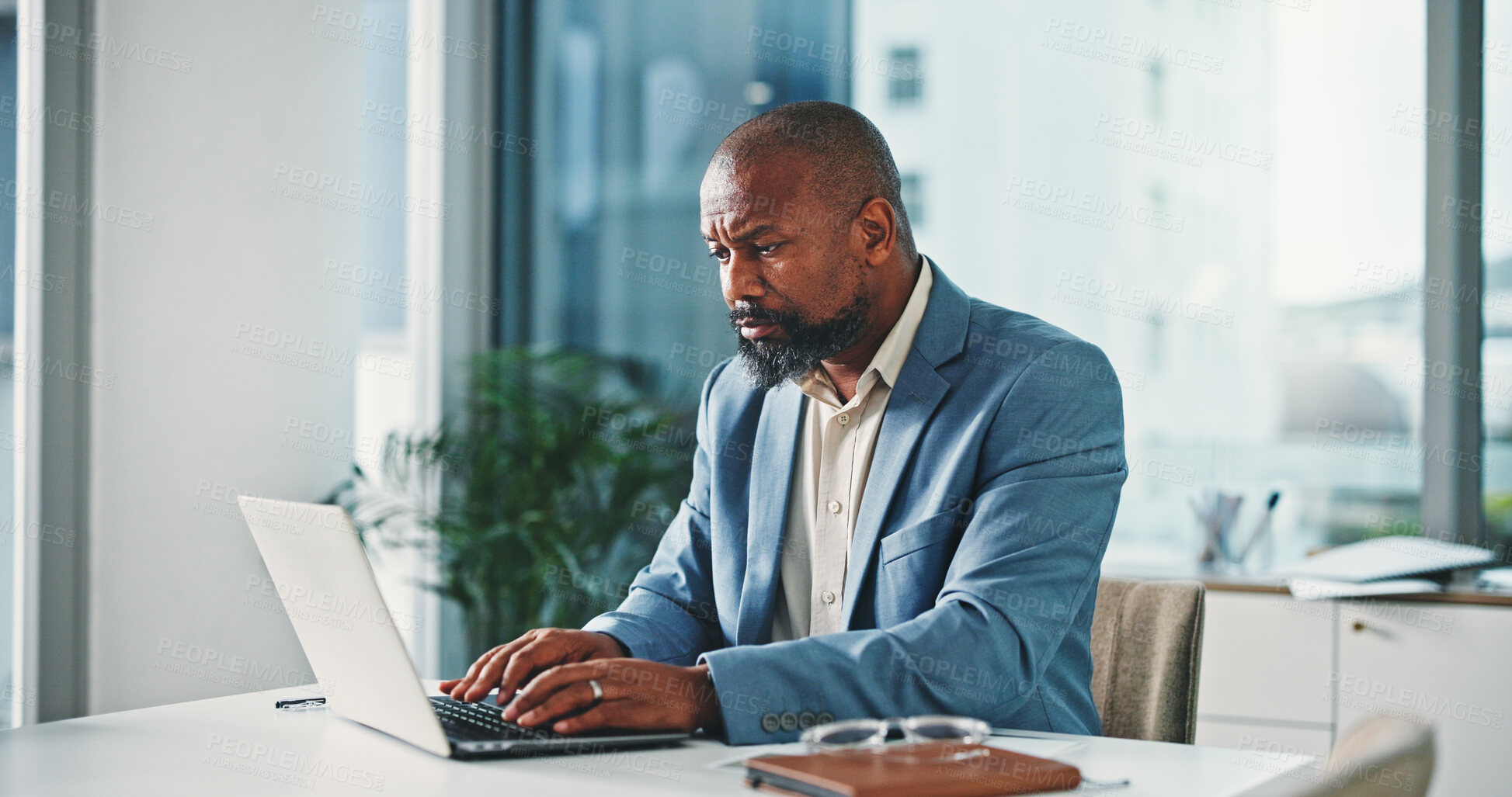 Buy stock photo Laptop, typing and black man in office with research for finance report with business budget. Computer, reading and African financial manager working on investment proposal with email in workplace.