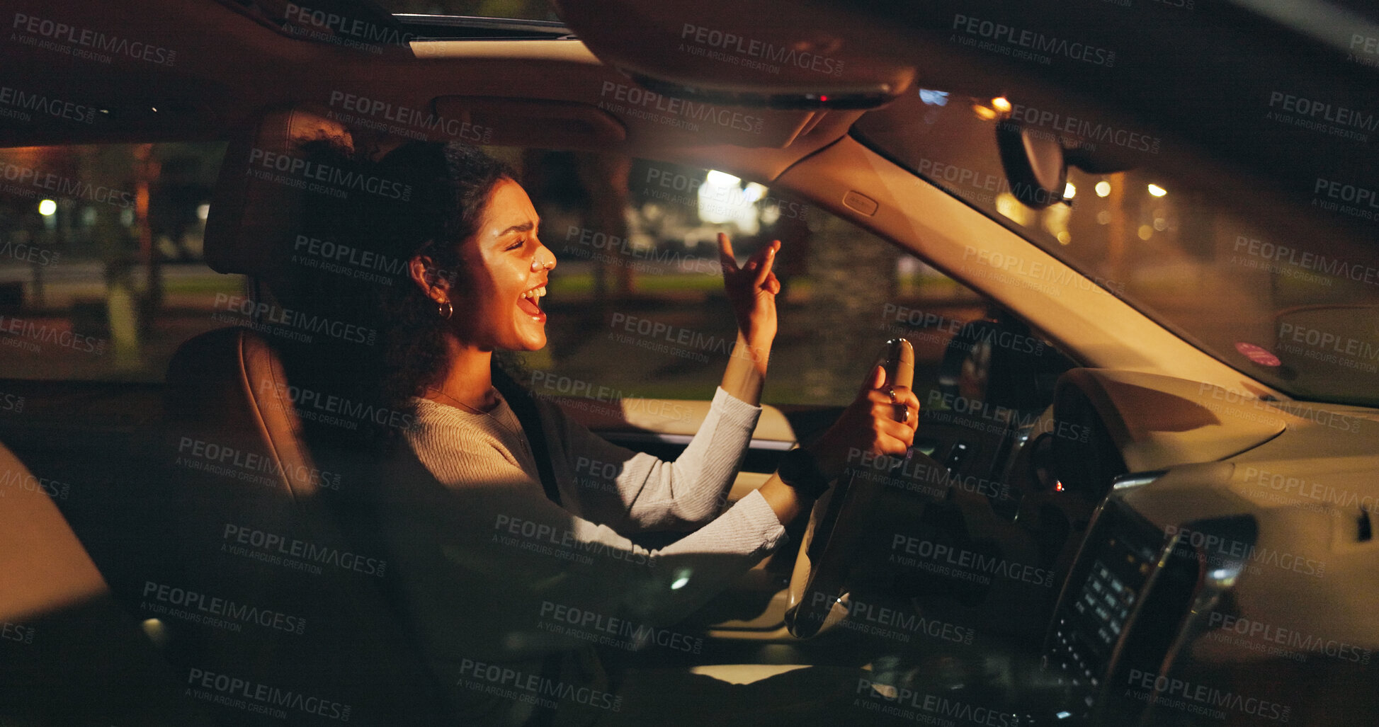Buy stock photo Singing, driving or happy woman in car at night, listening to radio or dancing for travel entertainment. Transport, music playlist or driver with sound system for fun, dark road or trip in vehicle