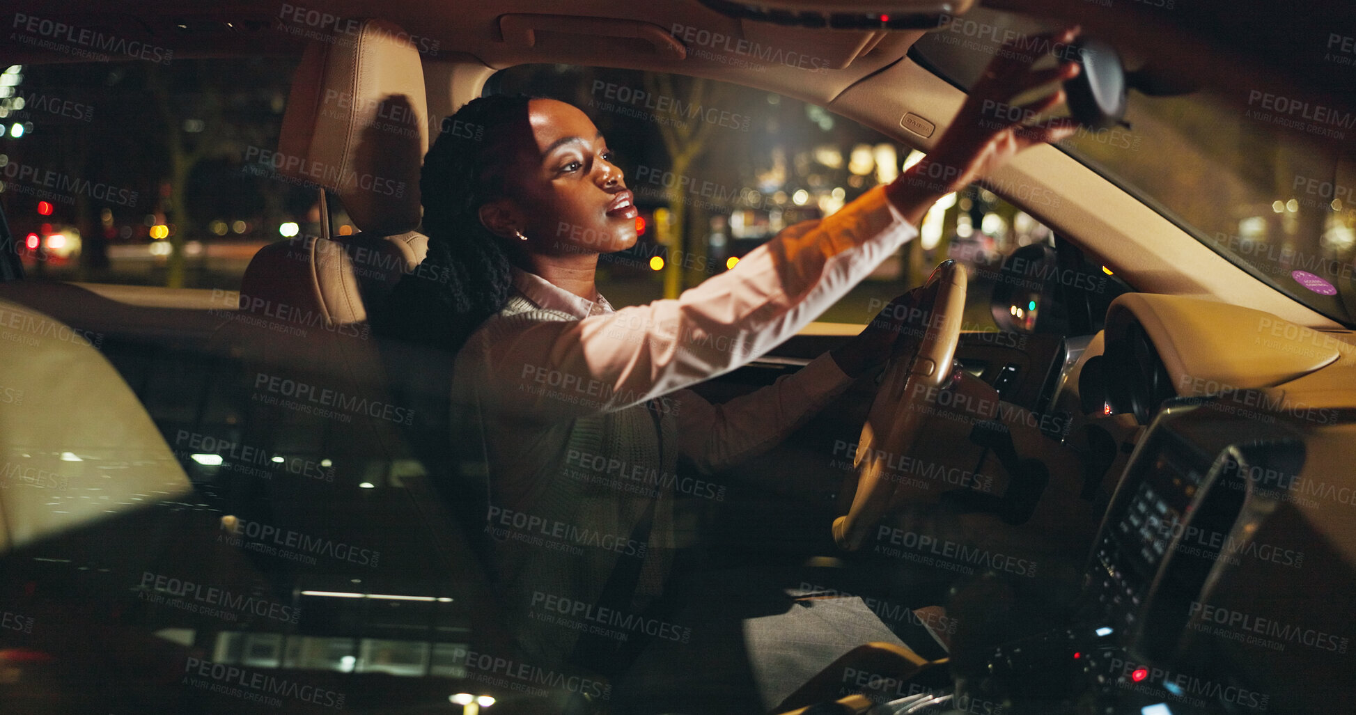Buy stock photo Night, rearview mirror or black woman in car with check, business commute or travel in urban area. Inspection, journey or girl in vehicle with evening trip, transportation or city drive after work.