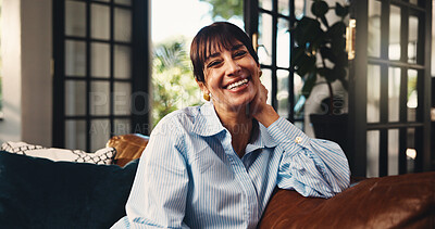 Buy stock photo Mature woman, portrait and happy on home sofa with confidence, comfort or positive attitude. Funny humor, apartment and female homeowner with smile on living room couch to relax, laugh and wellness