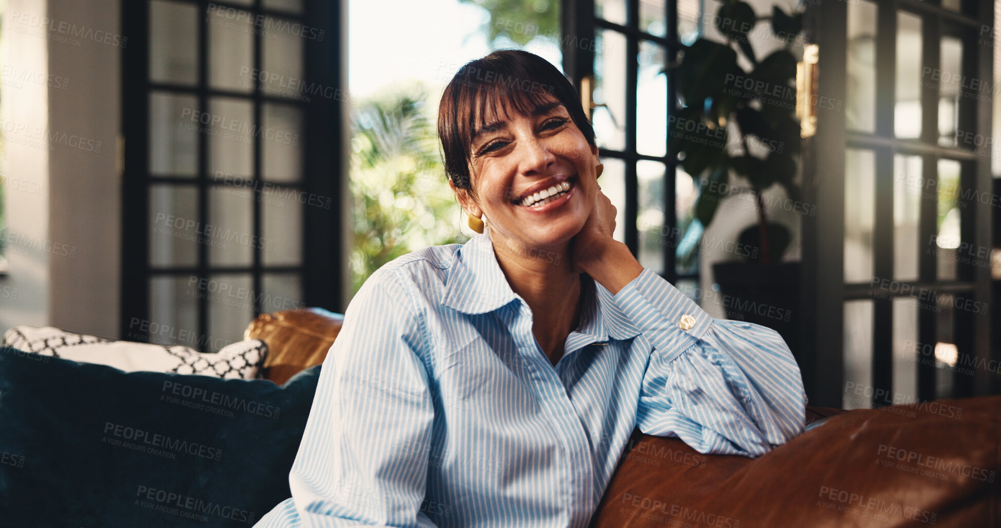 Buy stock photo Mature woman, portrait and happy on home sofa with confidence, comfort or positive attitude. Funny humor, apartment and female homeowner with smile on living room couch to relax, laugh and wellness