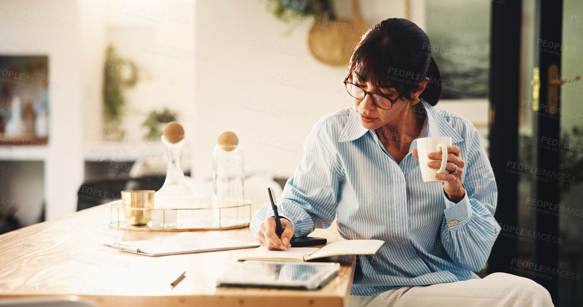 Buy stock photo Woman, writing and notebook with coffee in home for planning, finance reminder and payment timeline. Mature person, beverage and notes for household budget, tracking expenses and financial management