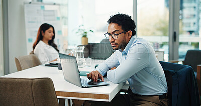 Buy stock photo Reading, info and man with laptop in office, serious and research for wealth management and website. Typing, online and person with tech for project, financial analyst and planning for annual budget