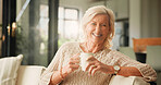 Happy, coffee and portrait of senior woman on sofa in home with relax in retirement in living room. Smile, tea and elderly female person drinking warm beverage in morning with rest, calm or peace.