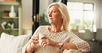Thinking, coffee and senior woman on sofa in home with nostalgia, memory or reflection in morning. Relax, ideas and elderly female person drinking tea in living room for retirement in apartment.