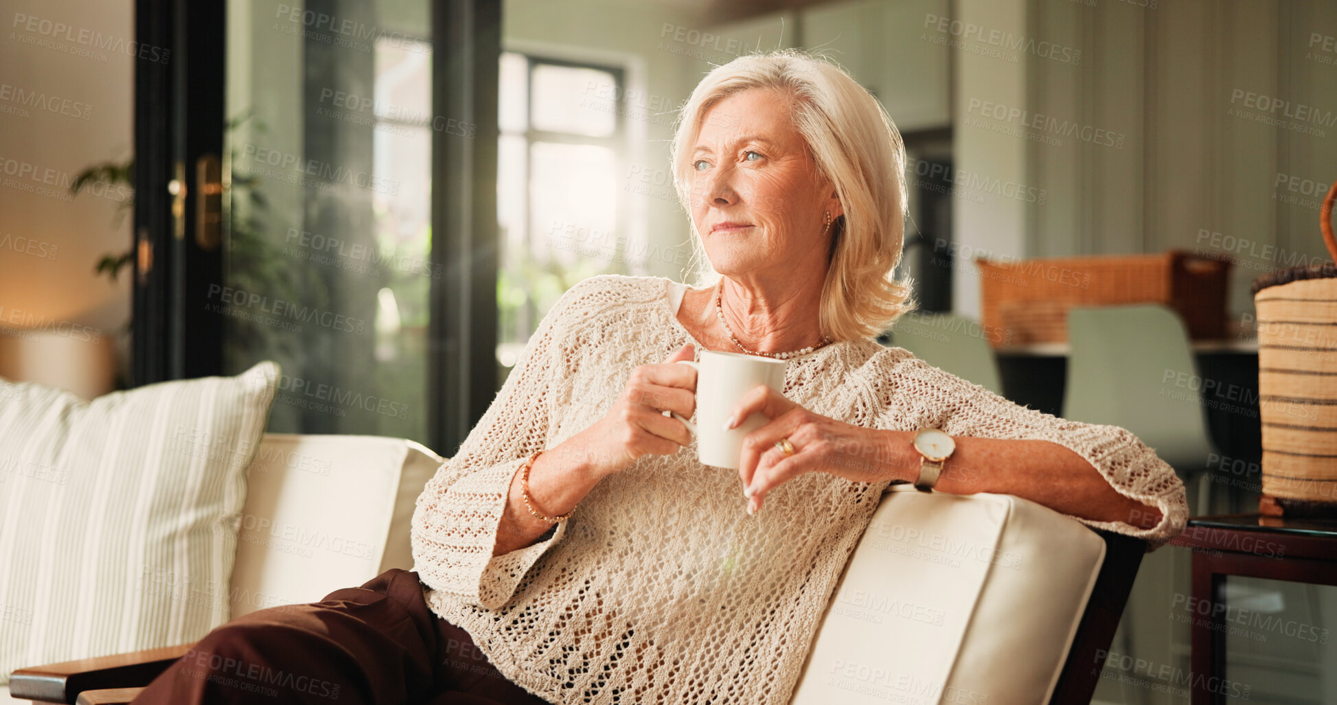 Buy stock photo Memory, coffee and senior woman on sofa in home with nostalgia, thinking or reflection in morning. Relax, ideas and elderly female person drinking tea in living room for retirement in apartment.