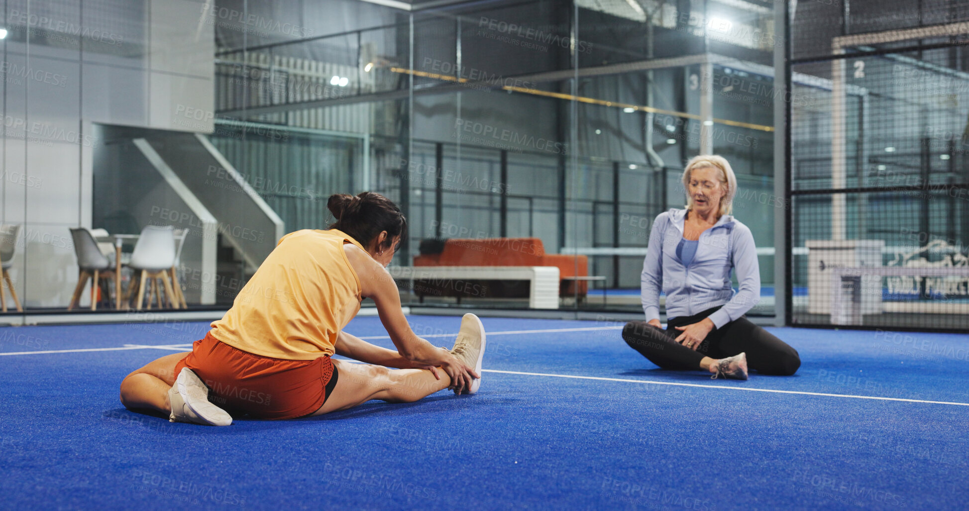 Buy stock photo Padel, sports and women on court stretching to prepare for game, match and competition. Indoor, fitness and mature people warm up for exercise, workout and training for practice, health and tennis