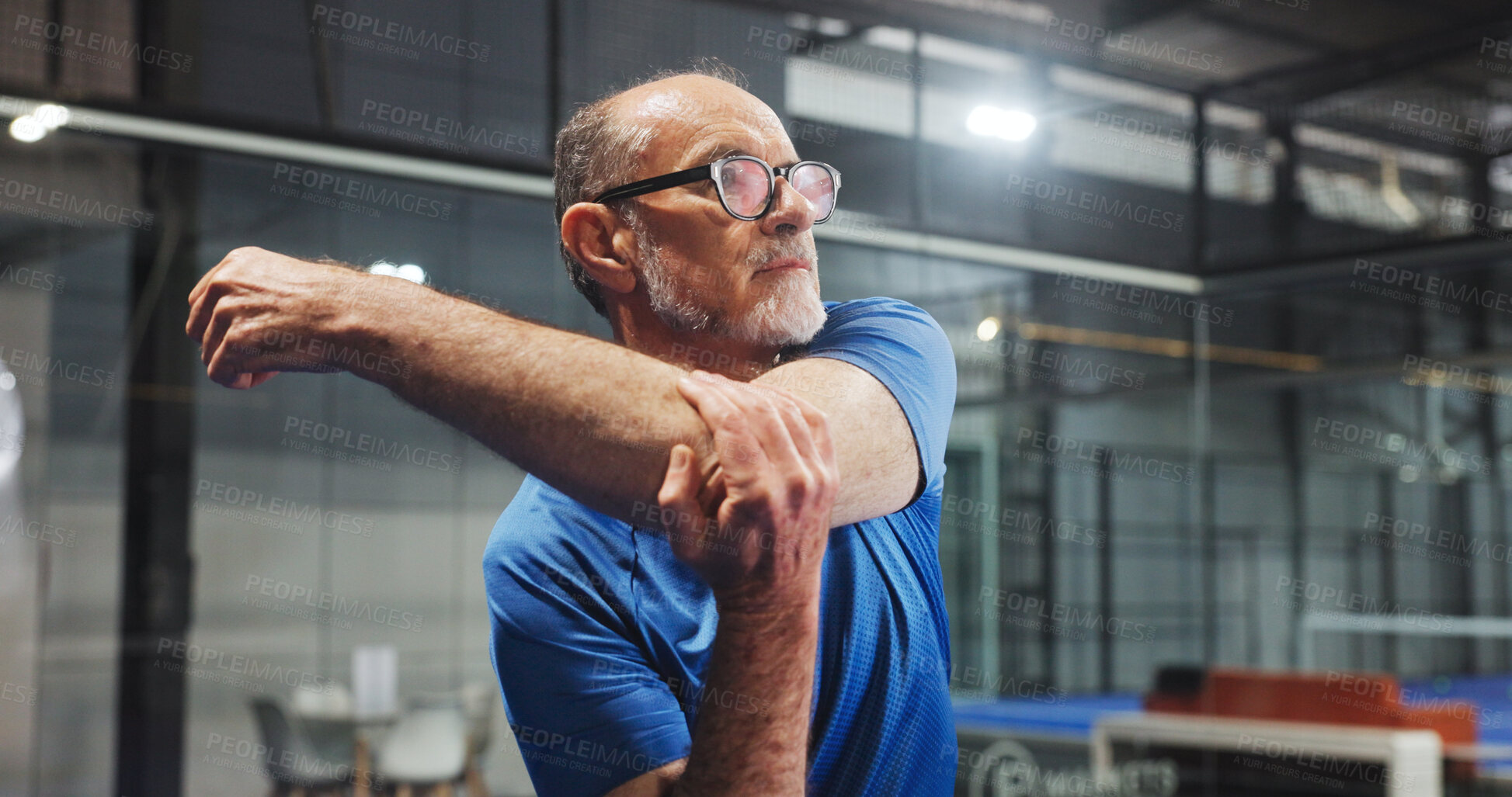 Buy stock photo Fitness, padel and old man stretching on court for match preparation, start practice and workout. Retirement health, senior person and arm warm up at indoor tennis club for sport performance or game