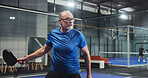 Padel, sports and senior man for game, tournament and competition on indoor court. Tennis club, athlete and person with racket for training, exercise and workout for challenge, practice and fitness
