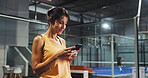 Sport practice, woman and phone on court for padel training schedule, match results or update. Tennis player, person and smile with smartphone at indoor health club for fitness app and online score