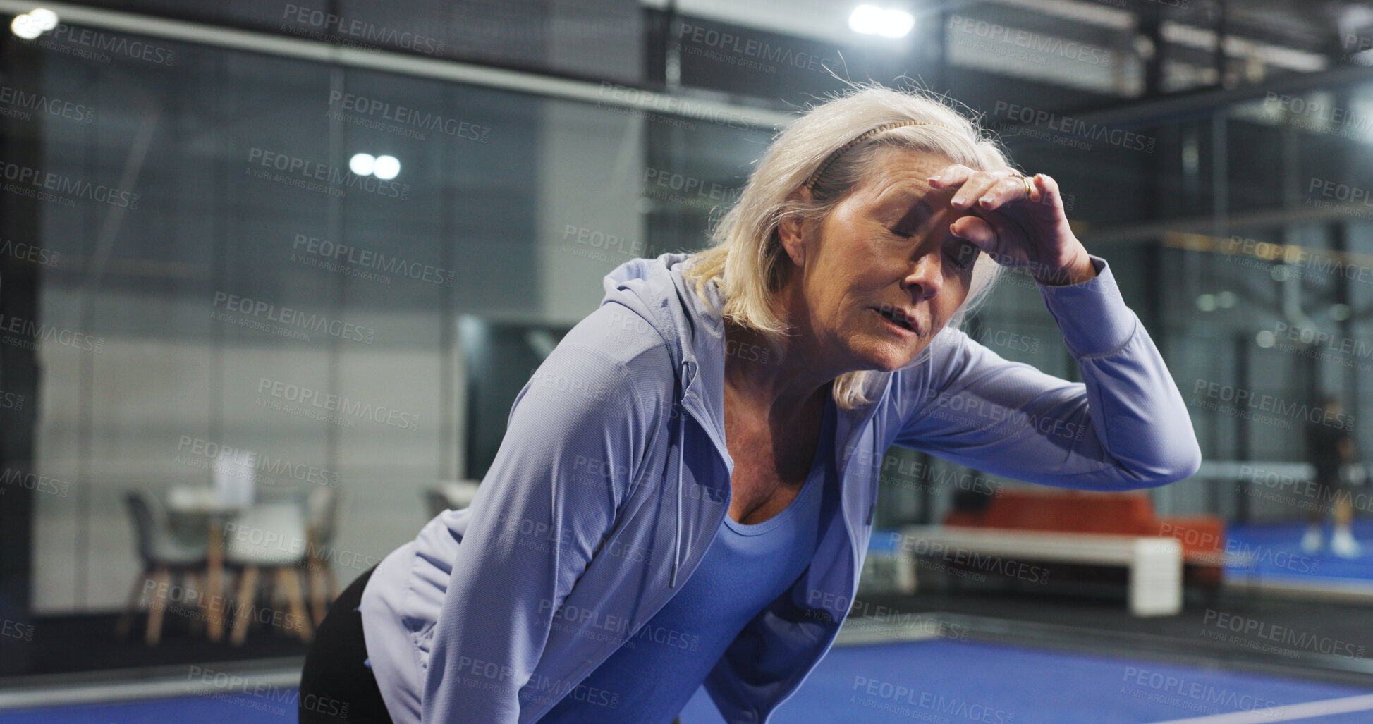 Buy stock photo Padel, tired and mature woman with sweat for game, match and training for challenge. Indoor court, sports and person breathe with fatigue, rest and break for workout, exercise and fitness for tennis