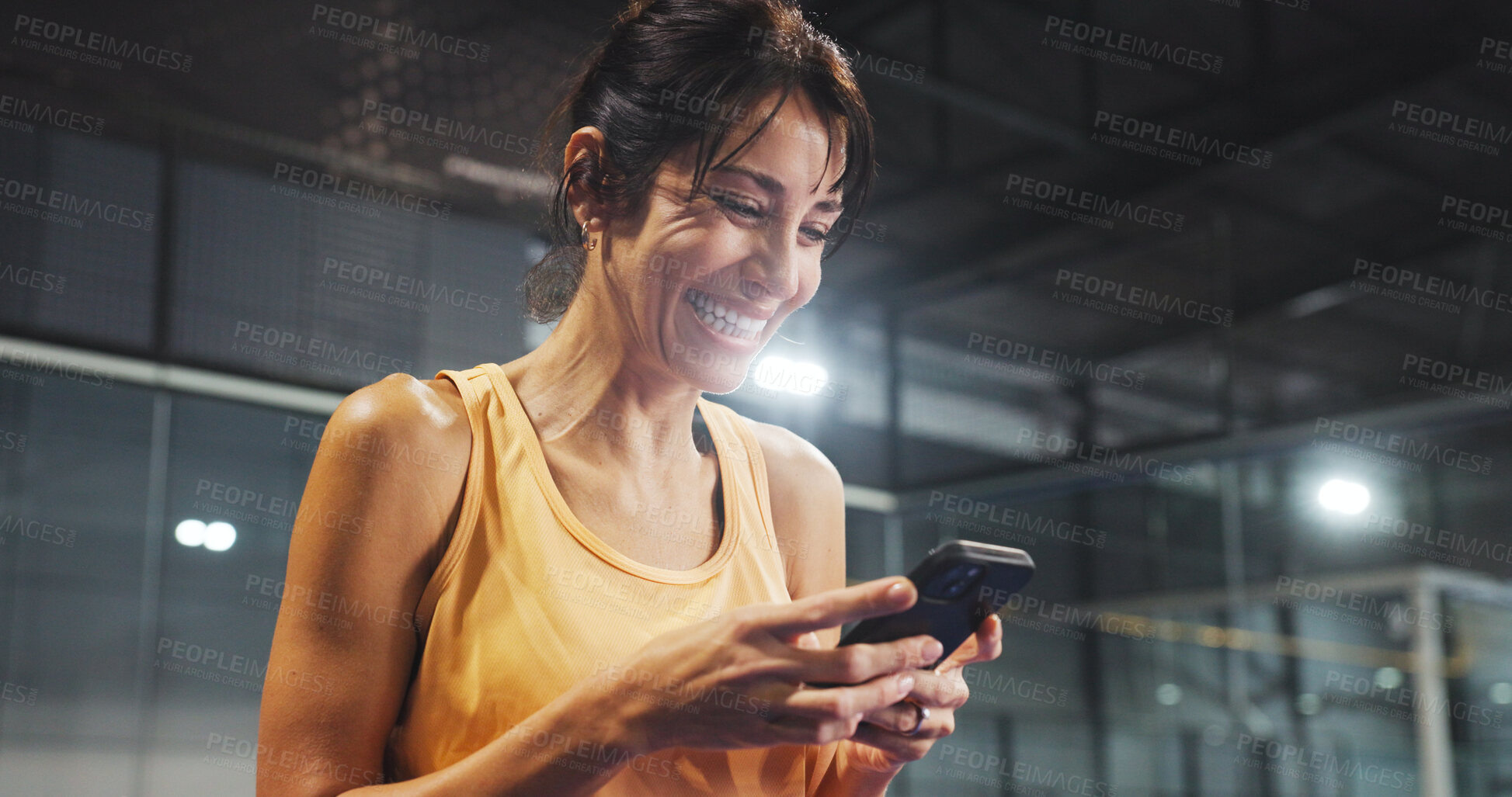 Buy stock photo Sport, woman and laughing with phone on court for funny text message, padel break or online meme. Tennis player, mature person or happy with smartphone at indoor health club for fitness joke or flare