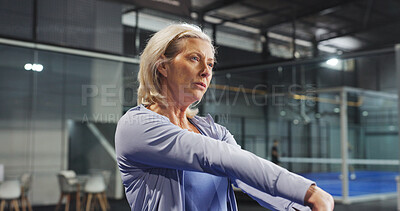 Buy stock photo Padel, exercise and mature woman on court stretching to prepare for game, match and competition. Indoor, sports and person warm up for fitness, workout and training for practice, health and tennis