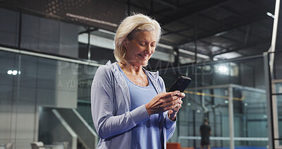 Buy stock photo Sport, senior woman and phone on court for padel match score, track performance and game break. Retirement fitness, elderly person and smartphone at indoor tennis club for practice schedule and chat