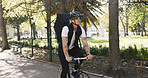 Courier, bike and delivery with man in park for package distribution, carbon footprint and shipping. Eco friendly transport, cycling and ecommerce parcel with person outdoor for export and cargo
