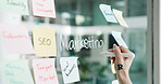 Advertising, hands writing or sticky note on glass wall for  branding, seo plan or target audience trends. Digital marketing, awareness strategy or person at board for campaign project, ideas or goal