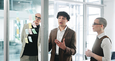 Buy stock photo Conversation, glass wall and planning with business people in office together for project management. Collaboration, brainstorming and sticky notes with corporate employee team at work for meeting