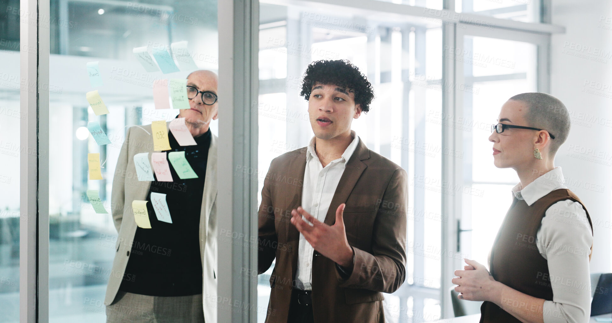Buy stock photo Conversation, glass wall and planning with business people in office together for project management. Collaboration, brainstorming and sticky notes with corporate employee team at work for meeting