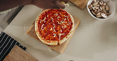 Buy stock photo Hands, person and cooking pizza at house with meal prep, organic ingredients and healthy food. Above, chef and cheese toppings for Italian cuisine, vegetables and culinary skills for homemade lunch