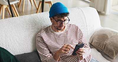 Buy stock photo Relax, phone and man on sofa in home with social media, contact or scrolling for networking. Notification, tech and male person with cellphone for connectivity, online or mobile app in living room