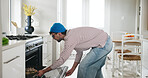 Cooking, pizza and oven with man in kitchen of home for lunch, meal prep and culinary cuisine. Nutrition, recipe and food with male person and tray in apartment for snack, chef and ingredients
