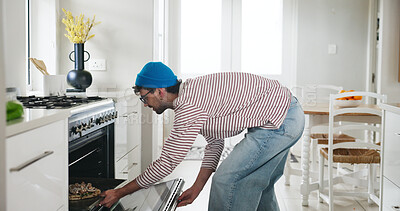 Buy stock photo Cooking, pizza and oven with man in kitchen of home for lunch, meal prep and culinary cuisine. Nutrition, recipe and food with male person and tray in apartment for snack, heating and ingredients