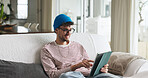 Relax, tablet and man on sofa in home with social media, contact or scroll for networking. Notification, tech and male person with communication for connectivity, online or mobile app in living room