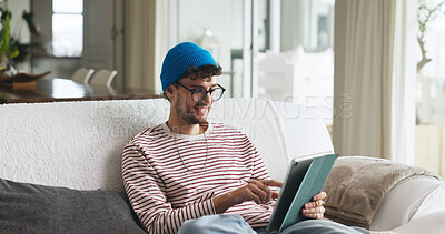 Buy stock photo Relax, tablet and man on sofa in home with social media, contact or scroll for networking. Notification, tech and male person with communication for connectivity, online or mobile app in living room