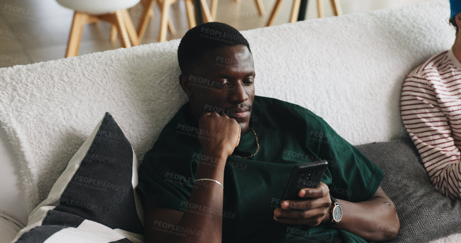 Buy stock photo Phone, reading and relax with man on sofa in living room of home for social media browsing. App, communication and text message chatting with person in apartment for break, free time or search