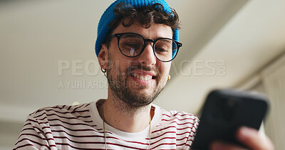 Buy stock photo Smile, phone and man on sofa in home with social media, contact or scrolling for networking. Low angle, tech and male person with cellphone for connectivity, online or mobile app in living room