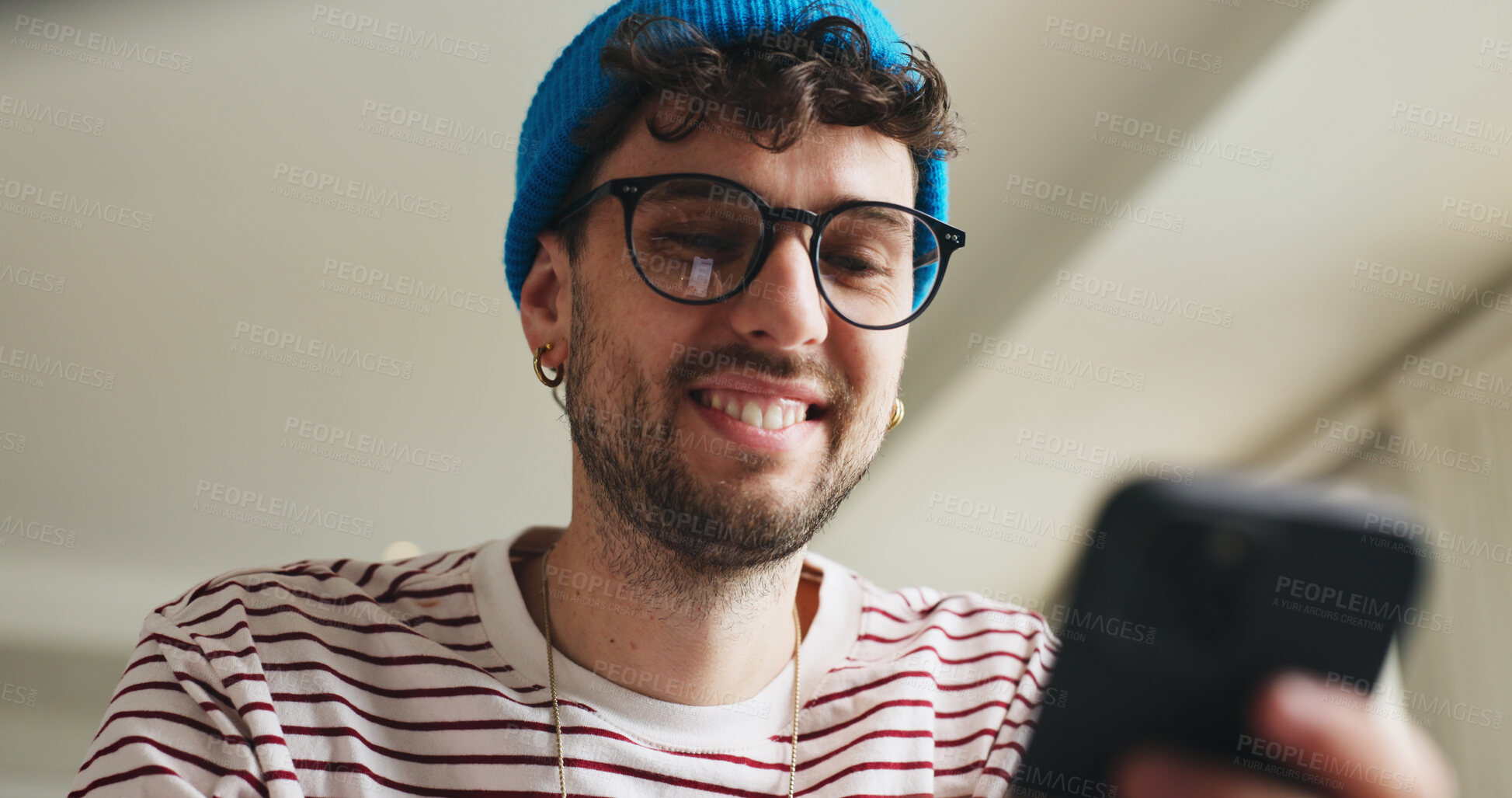 Buy stock photo Smile, phone and man on sofa in home with social media, contact or scrolling for networking. Low angle, tech and male person with cellphone for connectivity, online or mobile app in living room