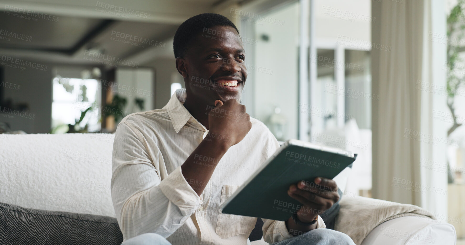 Buy stock photo Thinking, tablet and black man on sofa in home with ideas for university application in living room. Digital technology, planning and African male student with problem solving for college tuition.