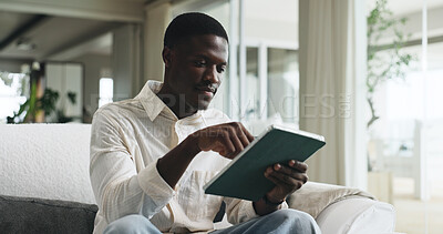Buy stock photo Freelancer, tablet and typing with black man on sofa for editor feedback, blog writer and research. Online review, report and remote worker or person in living room of home for press release schedule