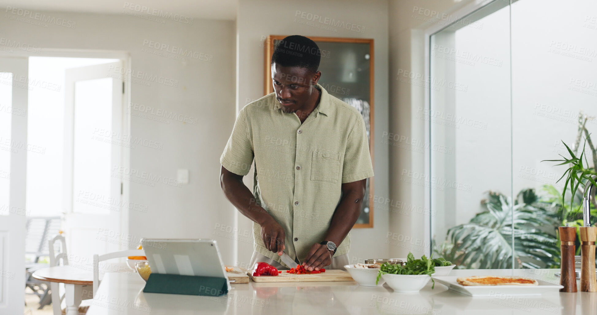 Buy stock photo Tablet, man and cooking with vegetables in kitchen for healthy lunch, online recipe or meal prep. Tech, black person and cut ingredients in home for dinner tutorial, website steps and culinary skills