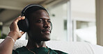House, headphones and black man on couch, thinking and listening to music, sound and playlist album. Calm, relax and person on sofa, audio tech and radio with daydreaming and streaming song in lounge